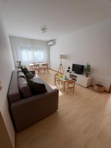 a living room with a couch and a table at Cosy Home Azores in Lagoa