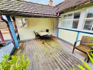 a wooden deck with a table and a bench on a house at Apartment Altstadt 50m vom Bodensee in Meersburg