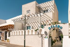 a building with a sign on the side of it at Dilino in Kamari