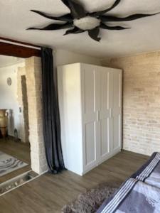 a bedroom with a ceiling fan and a door at fewo-wosink in Bad Krozingen +12 photos