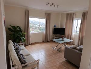 a living room with a couch and a table at Maison Zita in Venda do Atalhinho