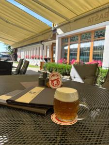a cup of beer sitting on a table at Hotel Pivovarská bašta in Vrchlabí
