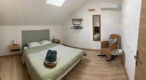 a bedroom with a bed and a desk and a chair at Maison en pierre, proche du Futuroscope in Scorbé-Clairvaux +14 photos