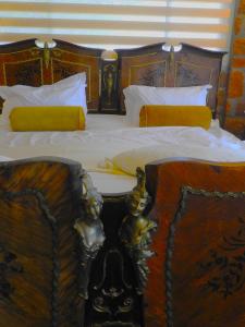 a bed with two figurines sitting on top of it at Ouhave Country Home in Osire