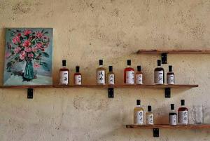 a shelf with bottles of alcohol on a wall at DALI FLOWER&CAT VILLa in Dali