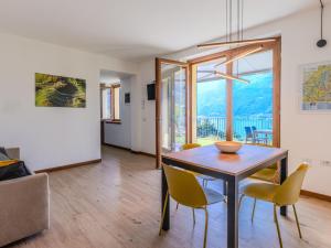 a dining room with a table and chairs at Holiday Home La Terrazza sul Lago by Interhome in Bellano