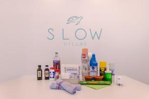 a sign for slow villas with a bunch of hygiene products at Villa Can Pulit by Slow Villas in Selva