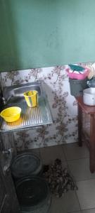 a dirty kitchen with a sink and a dirty floor at Harmony 2 bedroom apartment in Calabar