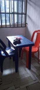 a blue table and a red chair and a table and a chair at Harmony 2 bedroom apartment in Calabar