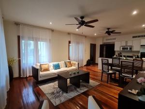 a living room with a couch and a table at Lovely 1-Bedroom Apartment - Pool, Private Beach in Gaynors