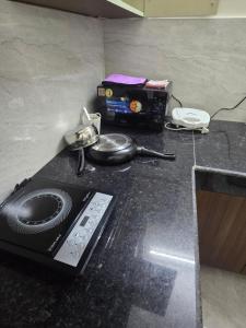 a kitchen counter with a microwave and a radio at Independent Homestay Near Airport in Mohali +2 photos