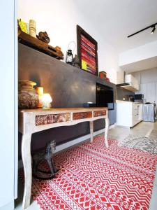 a table in a room with a red rug at Studio 207 Ebene Square Apartments in Quatre Bornes