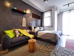 a bedroom with a bed and a couch at Studio 207 Ebene Square Apartments in Quatre Bornes