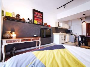 a large room with a kitchen and a large bed at Studio 207 Ebene Square Apartments in Quatre Bornes