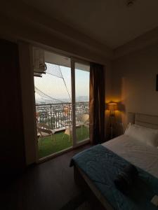 Un dormitorio con una cama y una ventana con balcón. en Visitor stop, en Greater Noida