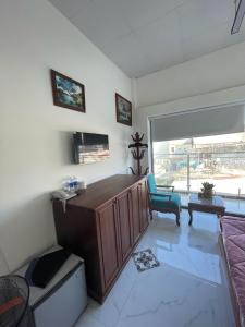 a room with a desk and a chair and a window at ONEA coffee Homestay in Trai Mat +12 photos