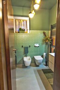 a bathroom with a toilet and a sink at Al Ventidue in Varese