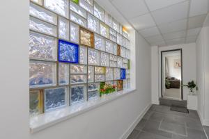 a wall of stained glass windows in a hallway at The Pier Escape Sea Breaze Stay in Clacton-on-Sea