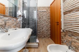 a bathroom with a white sink and a shower at Sea View Flat - close to the Beach and Fiumicino Airport in Isola Sacra +7 photos