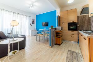 a kitchen and living room with a couch and a table at Sea View Flat - close to the Beach and Fiumicino Airport in Isola Sacra