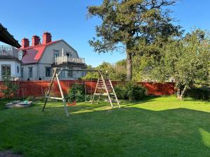 a playground in the yard of a house at Central floor with sauna, wi-fi and own entrance in Mariehamn +9 photos