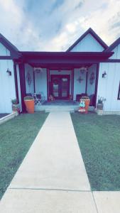a house with a walkway in front of it at The Rustic Belle in Waxahachie +8 photos