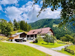 a house in the mountains with a driveway at Gästezimmer in Bauernhaus in Rennweg +4 photos