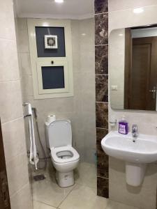 a bathroom with a toilet and a sink at 90 New Cairo - Full Services Apartments in Cairo