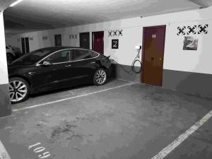 a black car parked in a parking garage at Apartamentos Zarautz Playa4, con piscina y garaje in Zarautz +5 photos