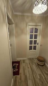 a room with a toilet and a door with a chandelier at Apartament Lux in Bucharest