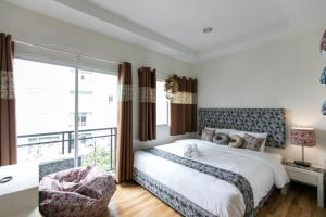 a bedroom with a bed and a large window at Bangkok River Loka Hotel in Bangkok
