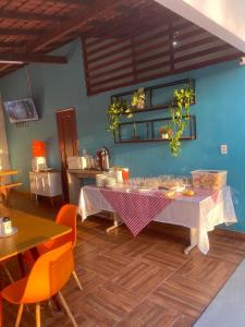 a dining room with a table and some chairs at Vila Suítes in Barcarena +15 photos