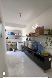 a kitchen with a counter with food on it at Casa Sol & Mar Guriri in São Mateus +6 photos
