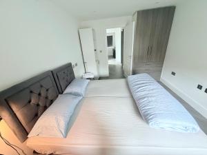 a large bed in a room with a large mattress at Side Separate Independent Annexe in Slough