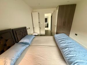 a large bed in a bedroom with a mattressvisorvisor at Side Separate Independent Annexe in Slough