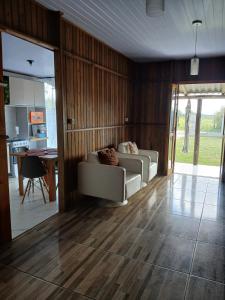 a living room with a couch and a table at Recanto Doce Lar in Passo De Torres