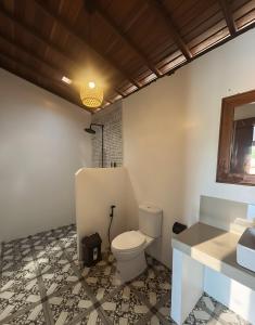 a bathroom with a toilet and a sink at Ginantary Cottages in Uluwatu +119 photos