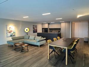 a living room with a couch and a table at Luxury Lake View Apartment Minusio by HolAp in Minusio
