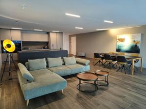 a living room with two couches and a table at Residenza Panoramic in Brione sopra Minusio