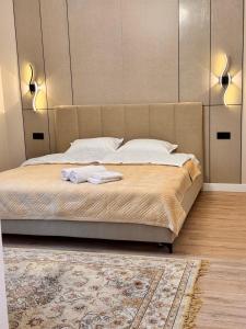 a bedroom with a bed with two towels on it at Premium Delux Astana in Zhezdi