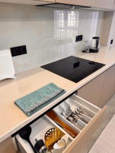 a kitchen with a counter top with an open drawer at Premium Delux Astana in Zhezdi