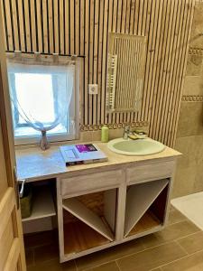a bathroom with a sink and a window at Maison style chalet in Montfroc +8 photos