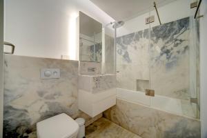 a bathroom with a toilet and a shower at Mirabilis Apartments - AAA23 in Lisbon +26 photos