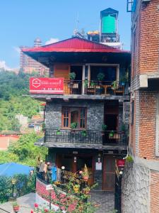 a building with balconies on the side of it at Bandipur Samira Hotel & Homestay - your comfort in heart of Bandipur in Bandipur
