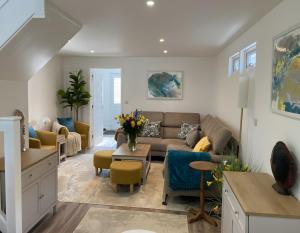 a living room with a couch and a table at Seahorse in Sark