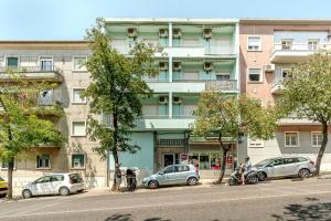 a group of cars parked in front of a building at Setubal Boutique Apartment I by Homing in Setubal