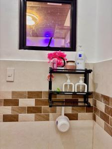 a shelf in the corner of a bathroom with a window at Athena & Storm the Bay Nook in Victoria