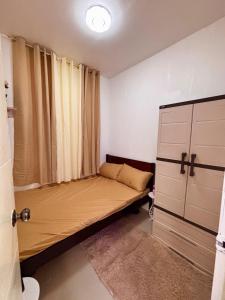 a small bedroom with a bed and a window at Athena & Storm the Bay Nook in Victoria