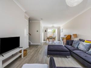 a living room with a couch and a tv at Charming Selsey Family Home Pass The Keys in Selsey