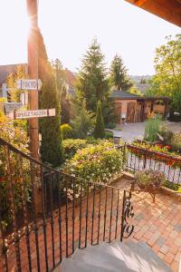 a wrought iron gate with street signs in a garden at Vintage Home Vendégház in Miskolctapolca